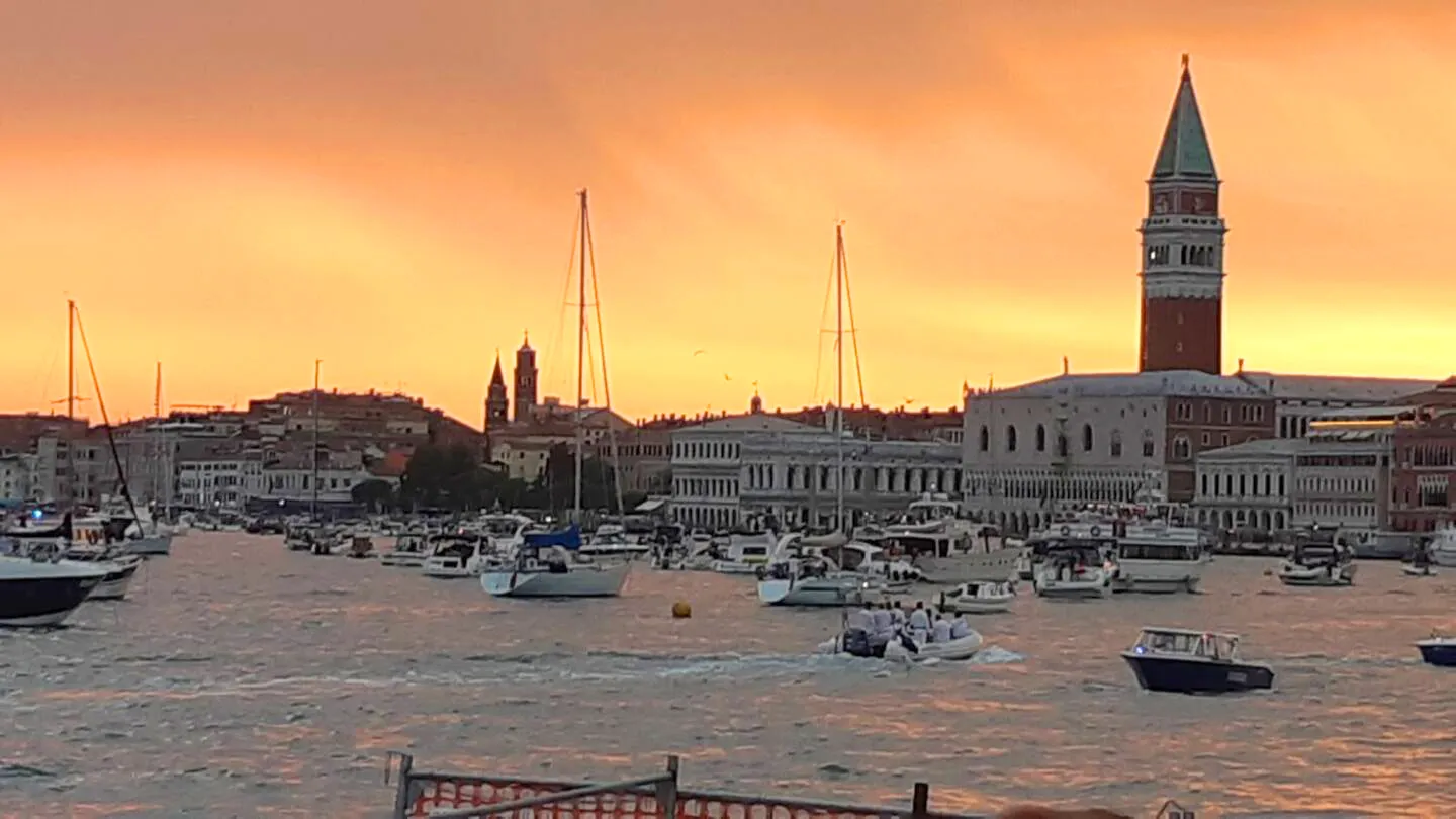 Golden sunset that enchants the harbor: Suite Jesolo gifts you magical spectacles with sailboats and historic architecture at short distance from the suites.